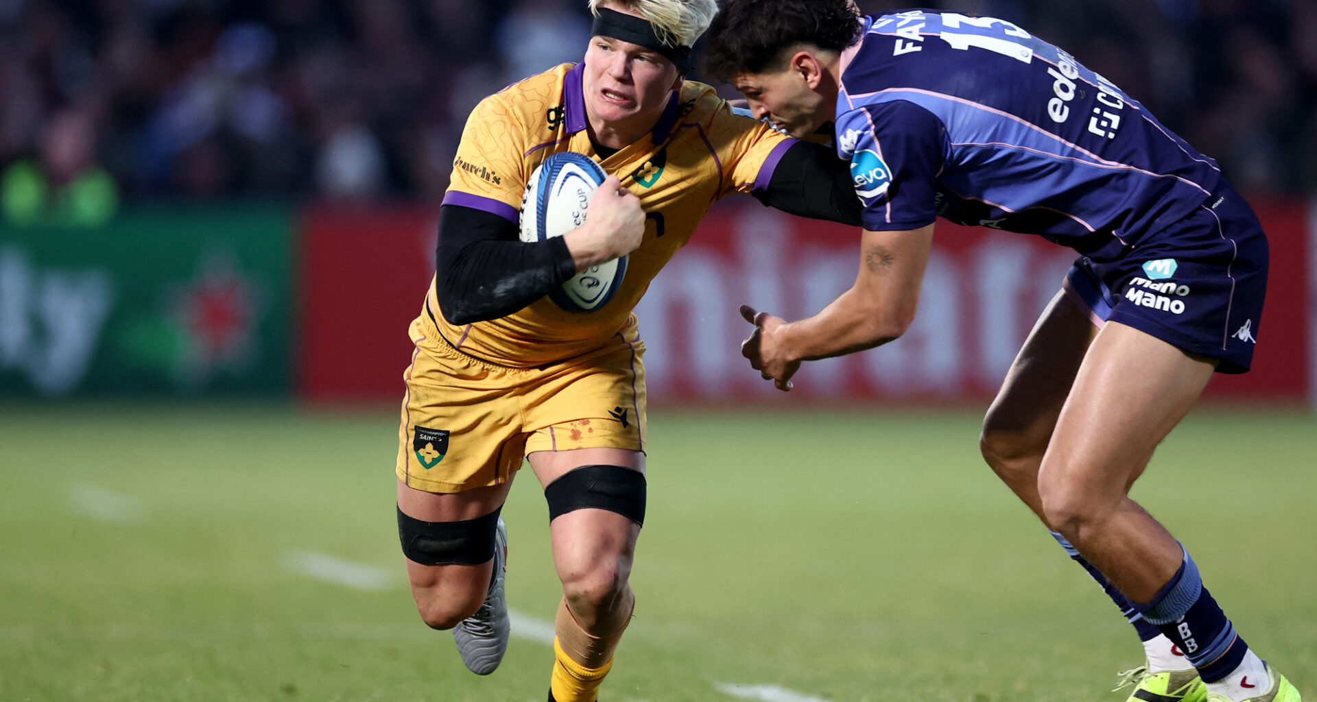 Northampton Saints' Henry Pollock fends off a tackle from Bordeaux Bègles' Nicolas Depoortere during the January 2026 European Champions Cup match.