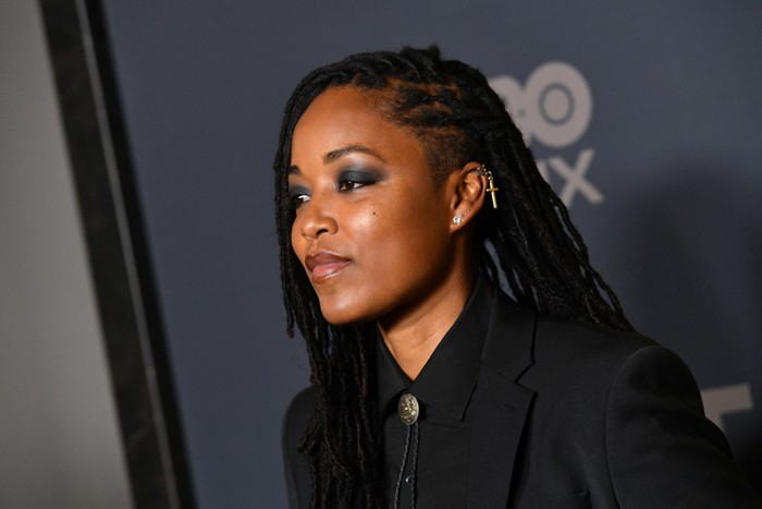 The Pitts' Ayesha Harris, in all black, looks straight ahead on the red carpet at the premiere for The Pitt.