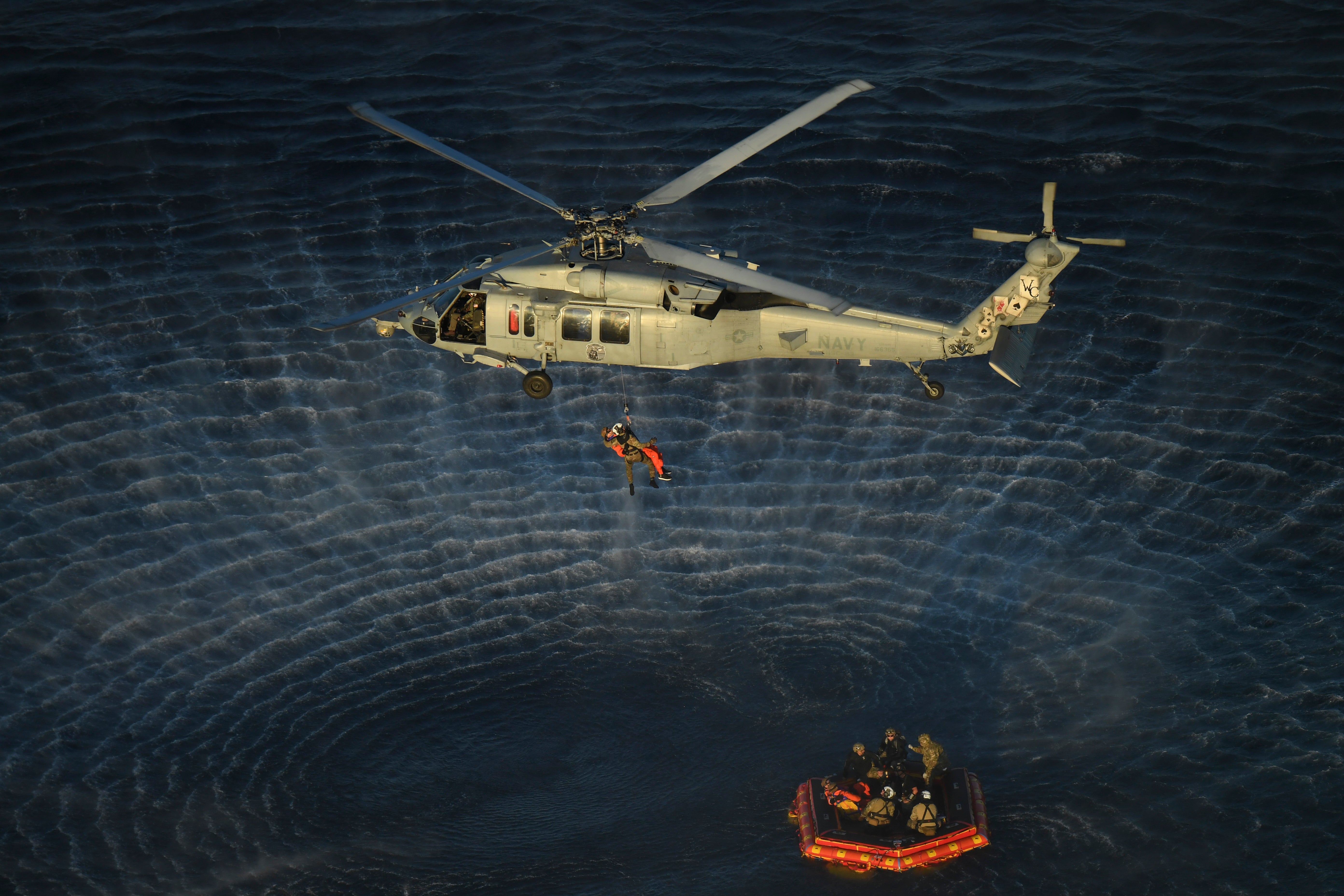 NASA Artemis II crew members are hoisted into a U.S. Navy MH-60 helicopter on Friday in the waters off of San Diego
