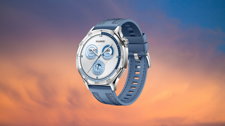 Blue Huawei Watch GT5 on a sunset background