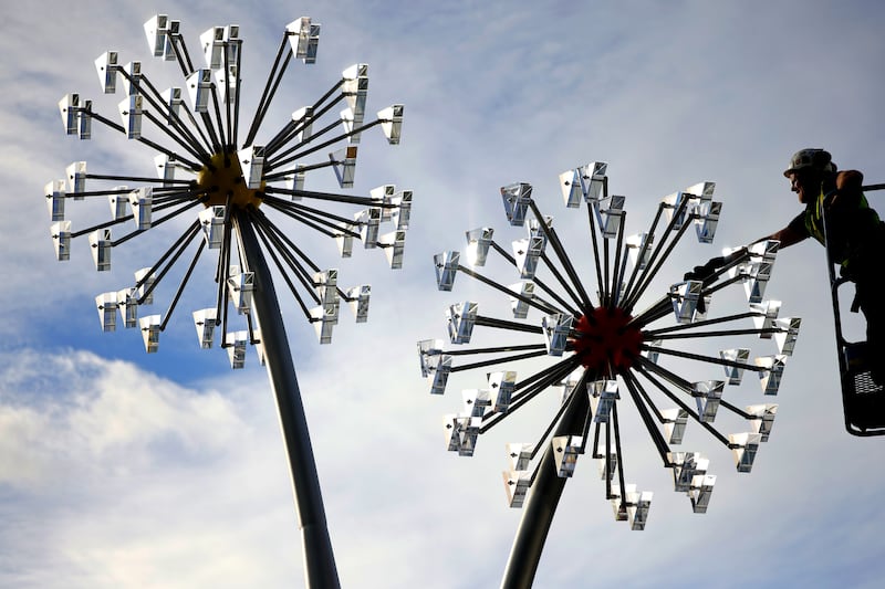 The finishing touches are made on the Dandelion Clocks sculptures by artist Remco de Fouw at the new  national children’s hospital in Dublin. Photograph: Chris Maddaloni