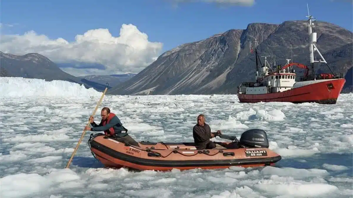 In Southern Greenland, Dominik Gräff (left) And A Crew Member Work Near The Ekas Glacier As The Vessel Adolf Jensen Stands Nearby.