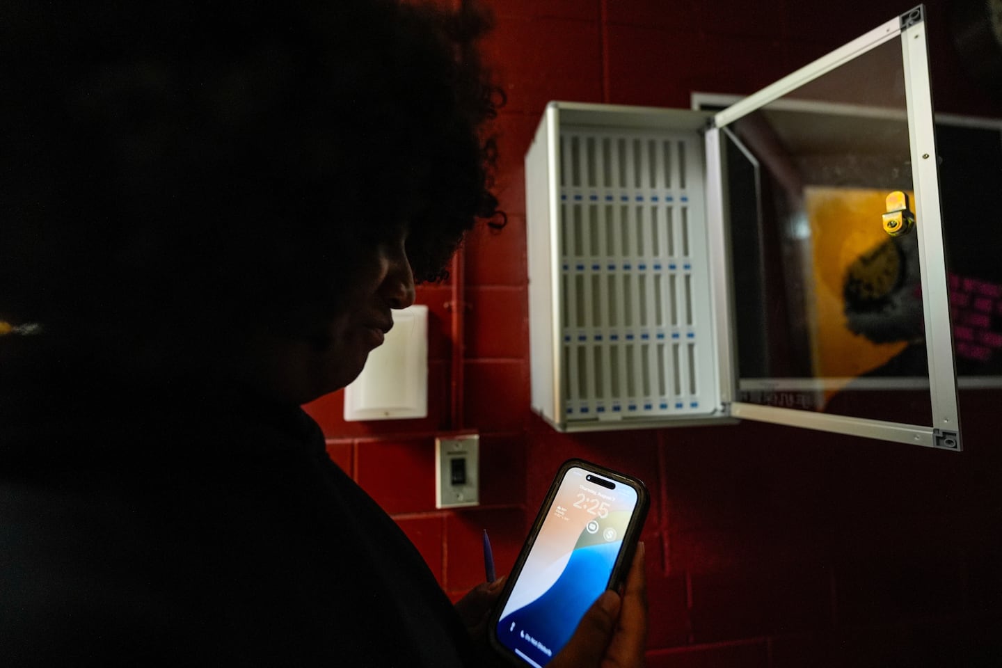 A student viewed her cell phone at Ronald McNair Sr. High School, in August in Atlanta.
