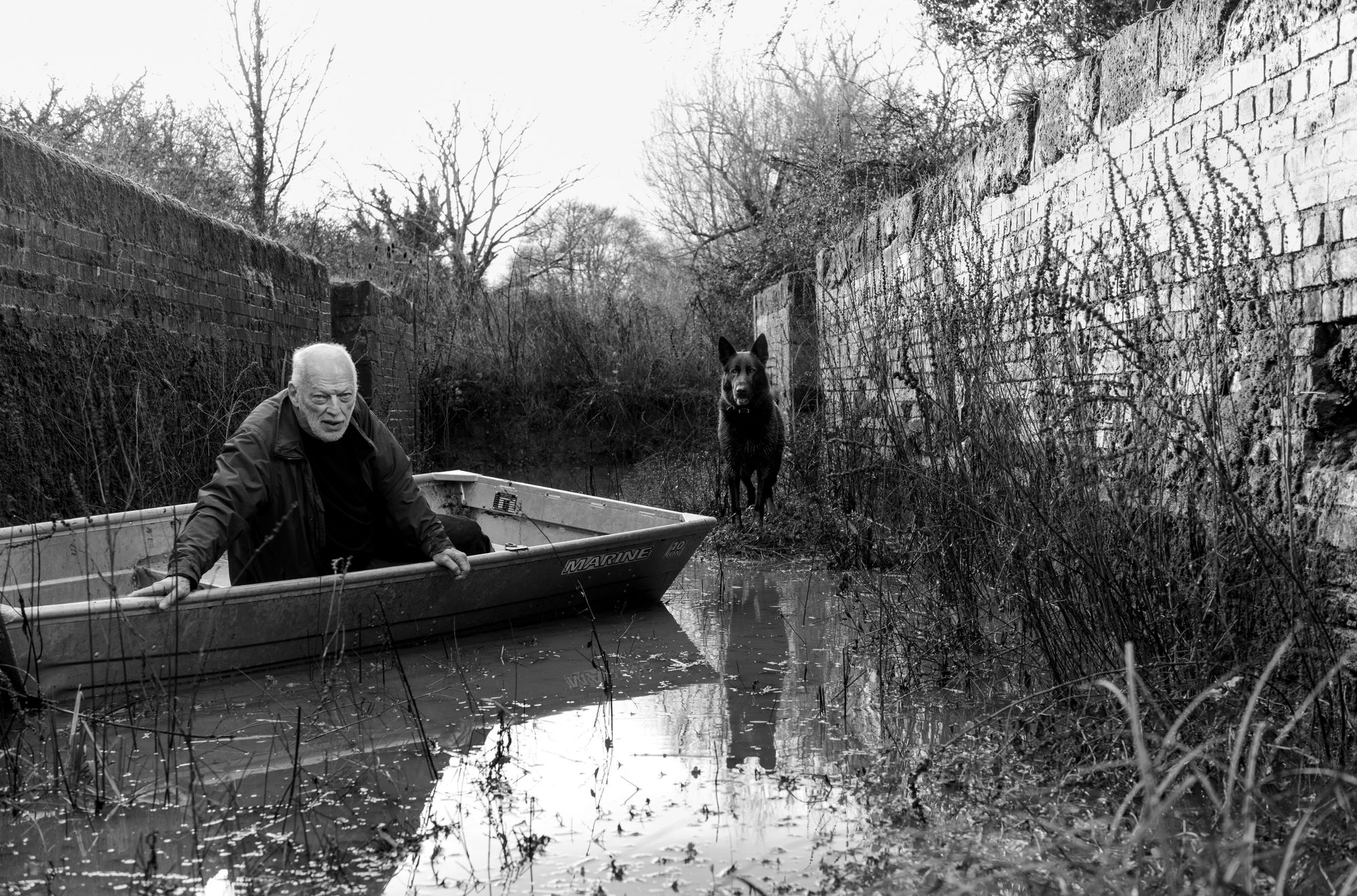 Gilmour from a boat with his dog Wesley, on guard duty