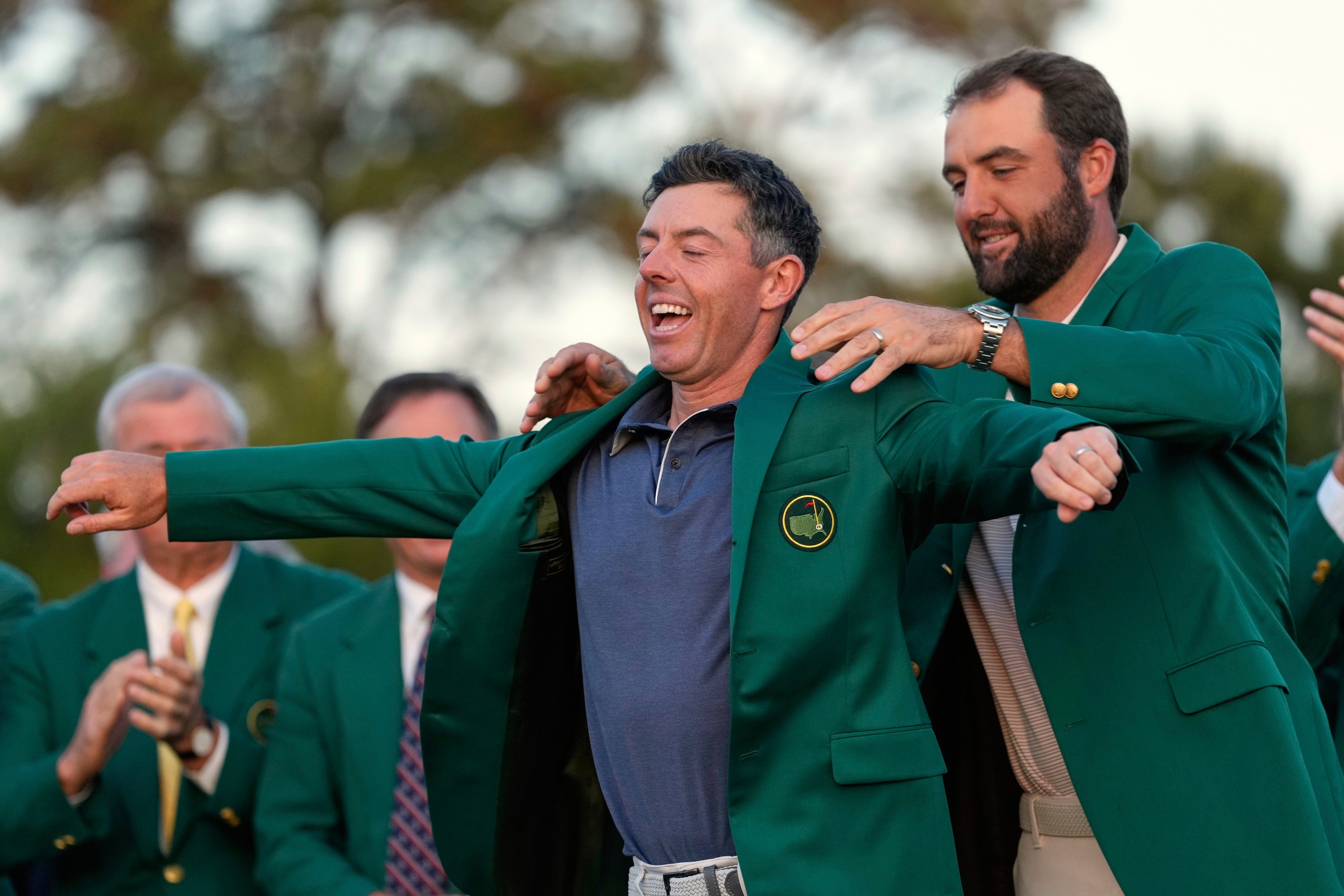 McIlroy receives the Green Jacket from Scottie Scheffler