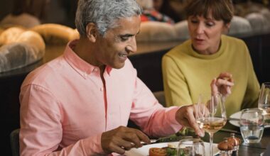 Mature couple in a discussion while eating a meal in a restaurant.