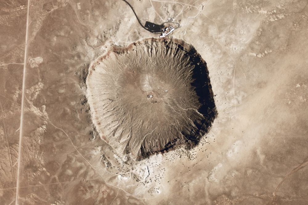 The Meteor Crater or Barringer Crater in Arizona is only about 50,000 years old and is the most well-preserved crater on Earth. Ancient craters like the Zhamanshin crater in Kazakhstan are far less well-preserved, and measuring its actual size is challenging becuase it was created almost one million years ago. New research shows that the Zhamanshin crater could be twice as large as thought, and far more destructive. Image Credit: By National Map Seamless Server - NASA Earth Observatory, Public Domain, https://commons.wikimedia.org/w/index.php?curid=7549781