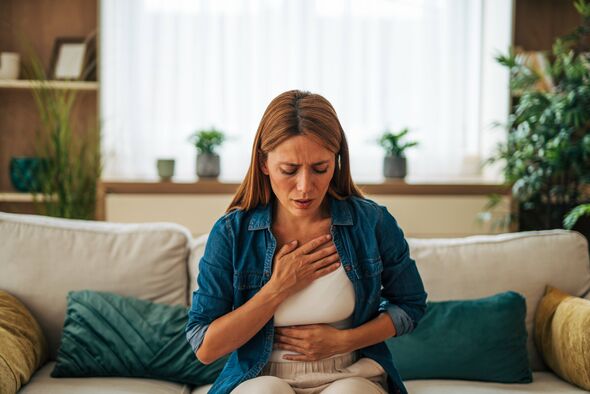 Mid adult woman experiencing sudden chest pain