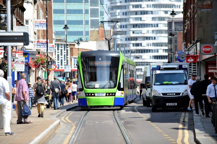 A Tramlink tram travels along George Street in Croydon, Surrey.