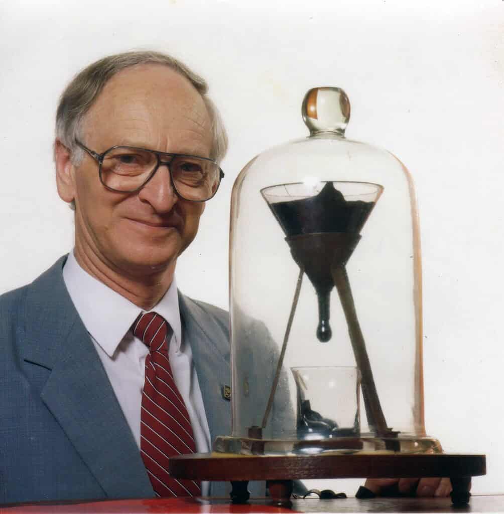 Scientist in a suit with scientific equipment, showcasing innovation and research.