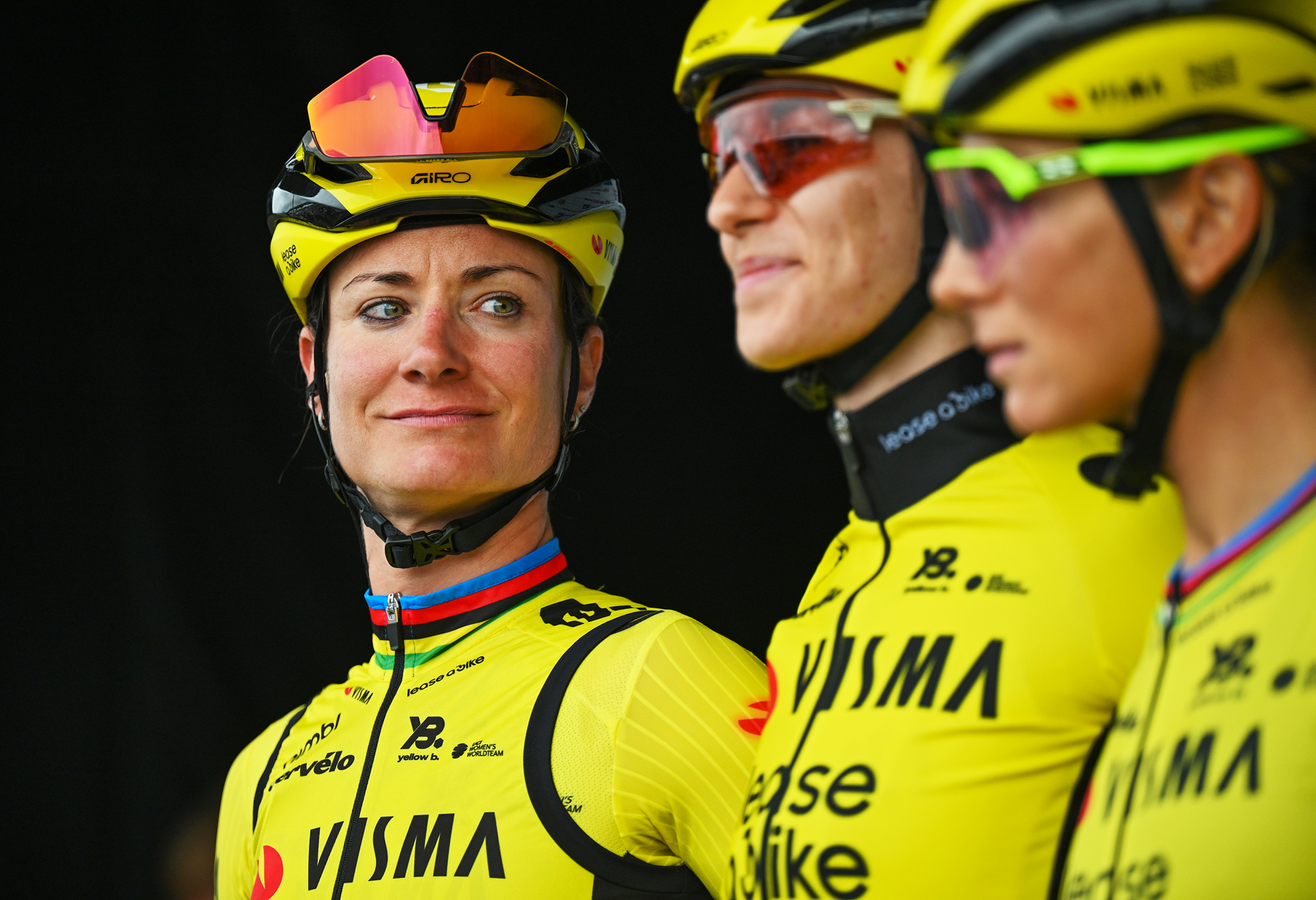 Marianne Vos (Visma-Lease a Bike) smiles as she looks across at her teammates at the team presentation ahead of the 2025 GP de Plouay
