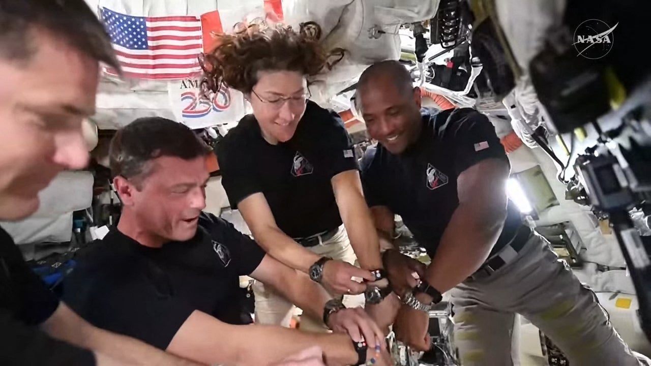 This screengrab from a Nasa livestream shows Artemis II crew members Jeremy Hansen, Reid Wiseman, Christina Koch and Victor Glover synchronising their watches aboard the Orion spacecraft on 6 April 2026