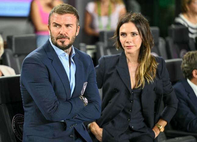 Inter Miami's president and co-owner David Beckham and his wife Victoria Beckham watch from the sidelines before the start of the Major League Soccer (MLS) playoff football match between Inter Miami and Nashville SC at Chase Stadium in Fort Lauderdale, Florida on October 24, 2025. (Photo by CHANDAN KHANNA / AFP) (Photo by CHANDAN KHANNA/AFP via Getty Images)
