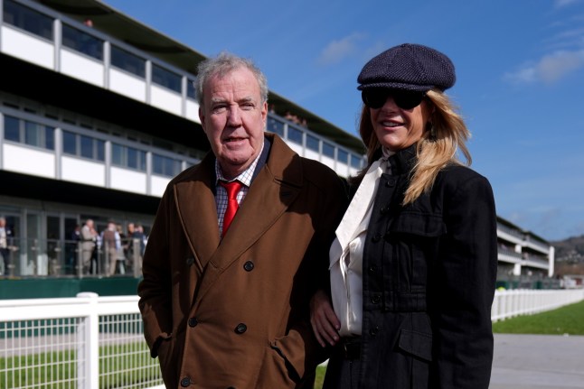 Jeremy Clarkson and Lisa Hogan on day four of the 2026 Cheltenham Festival at Cheltenham Racecourse. Picture date: Friday March 13, 2026. PA Photo. Photo credit should read: Joe Giddens/PA Wire. RESTRICTIONS: Use subject to restrictions. Editorial use only, no commercial use without prior consent from rights holder.