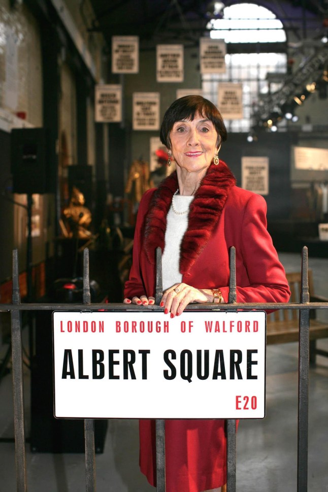 For use in UK, Ireland or Benelux countries only BBC undated handout photo of June Brown behind an Albert square, street sign. Issue date: Monday April 4, 2022. PA Photo. June Brown, best known for her role as chain-smoking Dot Cotton, has died at the age of 95, the BBC has announced. The actress died at her home in Surrey on Sunday evening with her family by her side. See PA story DEATH Brown. Photo credit should read: BBC/PA Wire NOTE TO EDITORS: This handout photo may only be used in for editorial reporting purposes for the contemporaneous illustration of events, things or the people in the image or facts mentioned in the caption. Reuse of the picture may require further permission from the copyright holder.