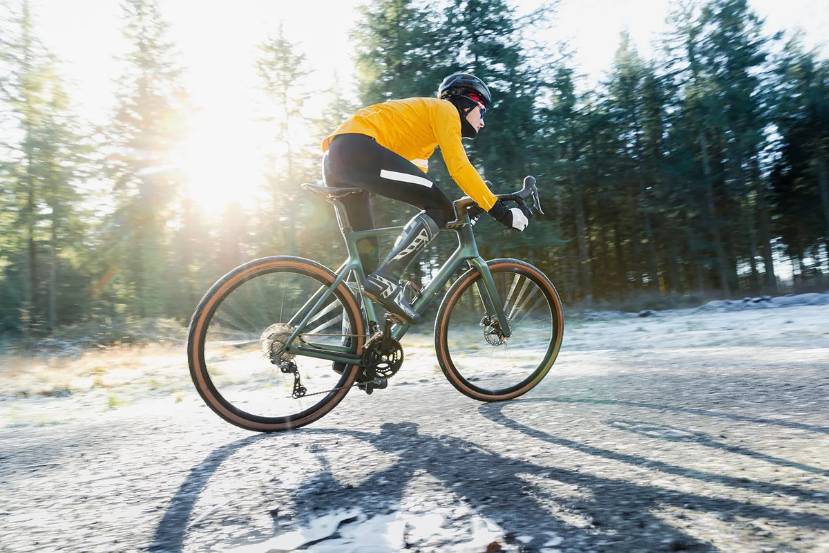 Cyclist in yellow top riding the Scott Addict Gravel 30 bike