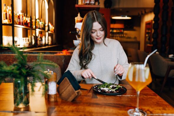 Young woman enjoying a healthy meal at a cozy restaurant