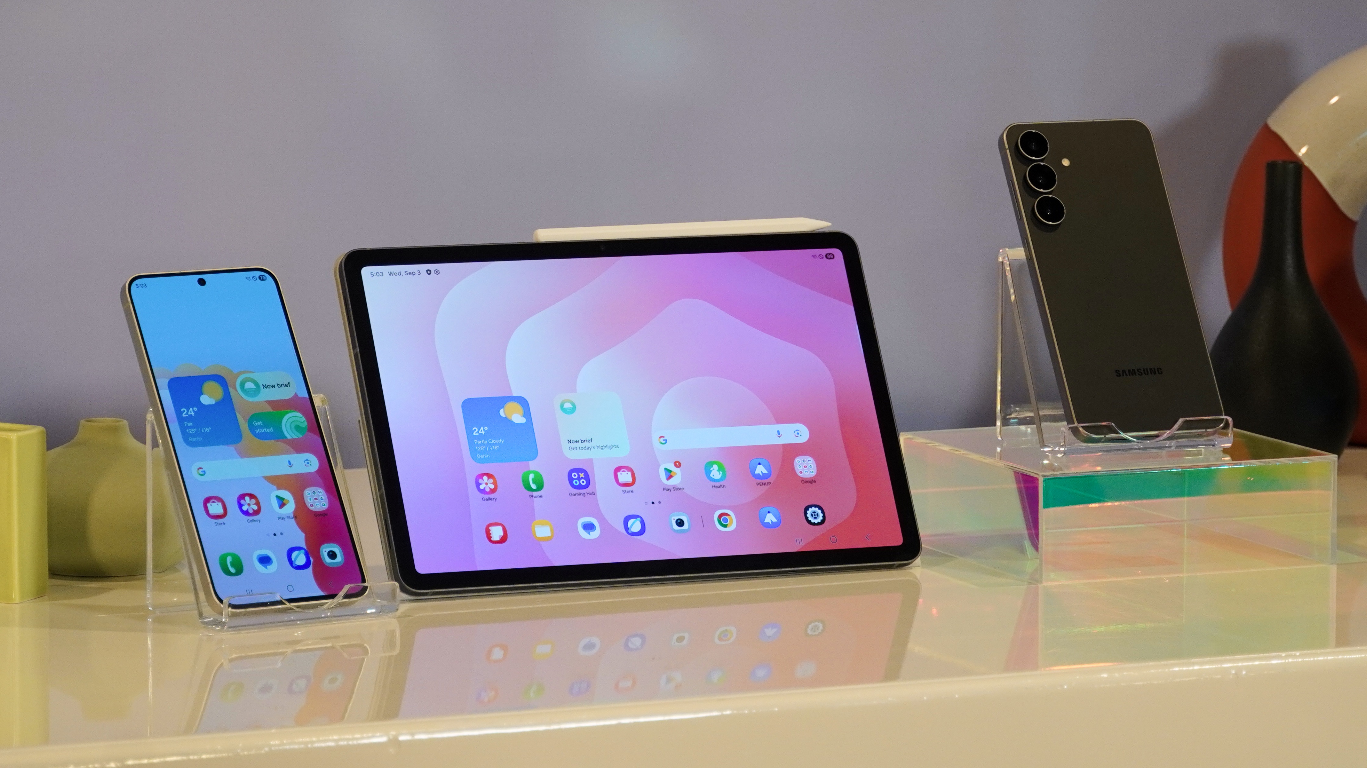 The Samsung Galaxy Tab S11 in between two Samsung Galaxy S25 FE models.