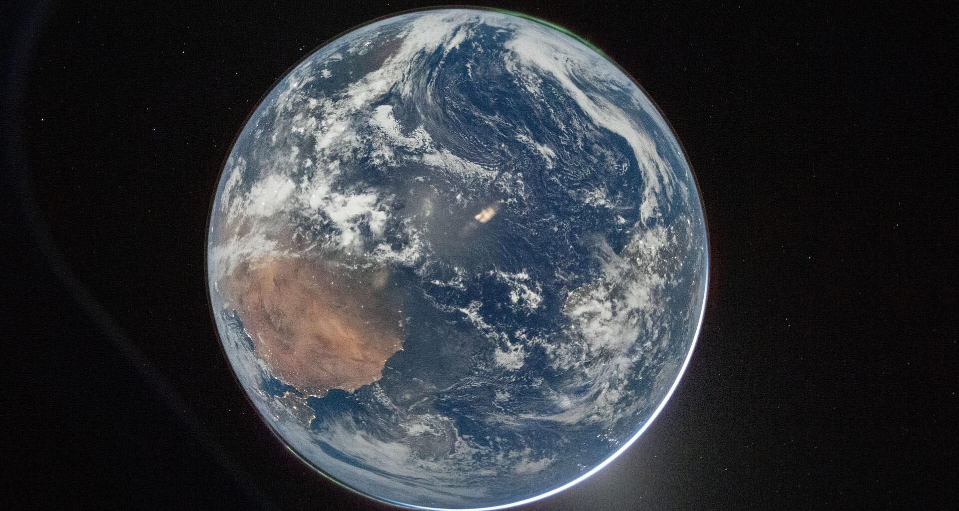 A view of Earth from Artemis II with the northern and south lights at each pole