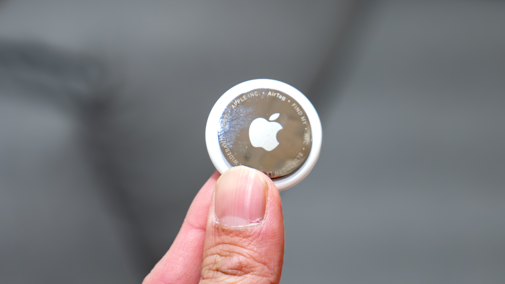 Apple AirTag 2 held in the hand.