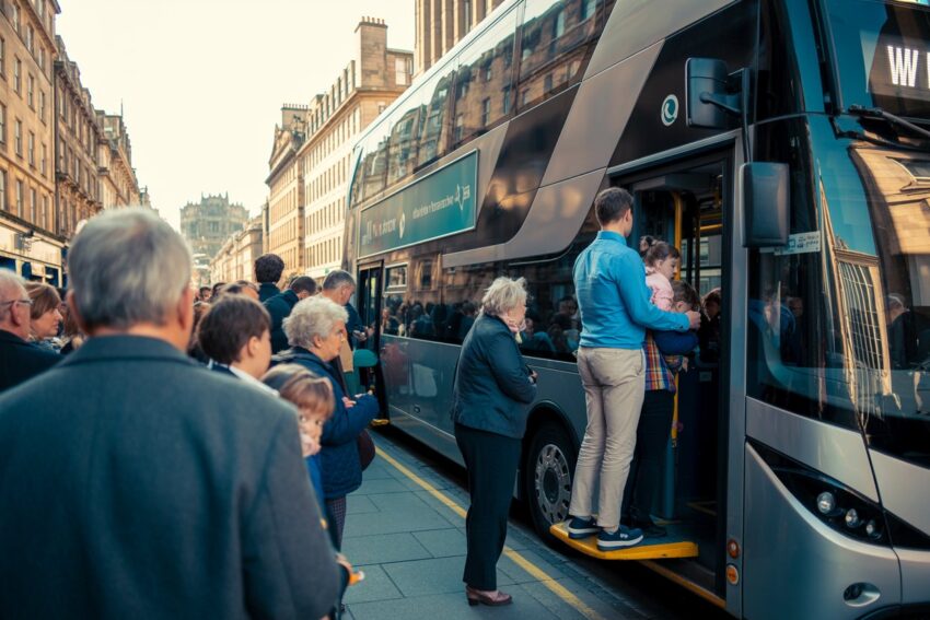 Public waiting to board a double-decker bus in scotland amid new free bus plan.