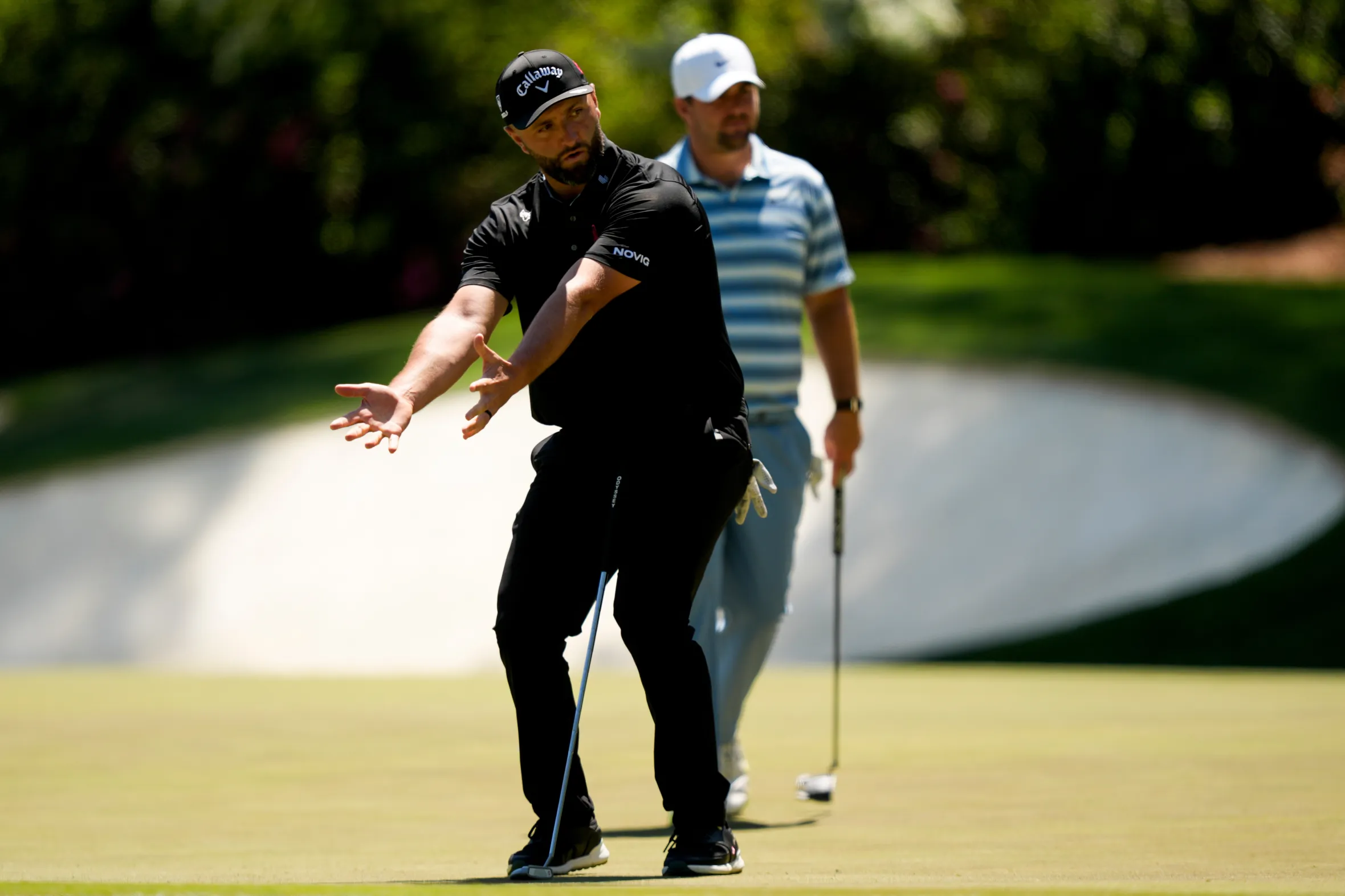 Jon Rahm reacts to a missed putt during the Masters golf tournament.