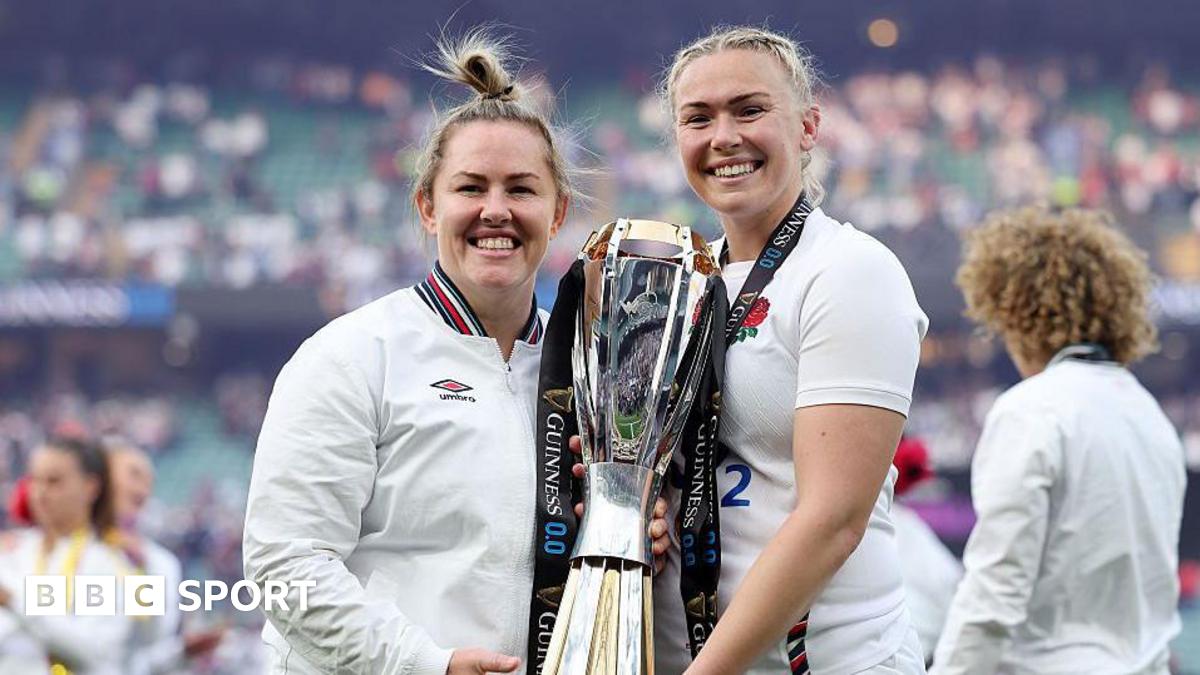 Marlie Packer and Rosie Galligan pose for a photograph holding the RWC trophy