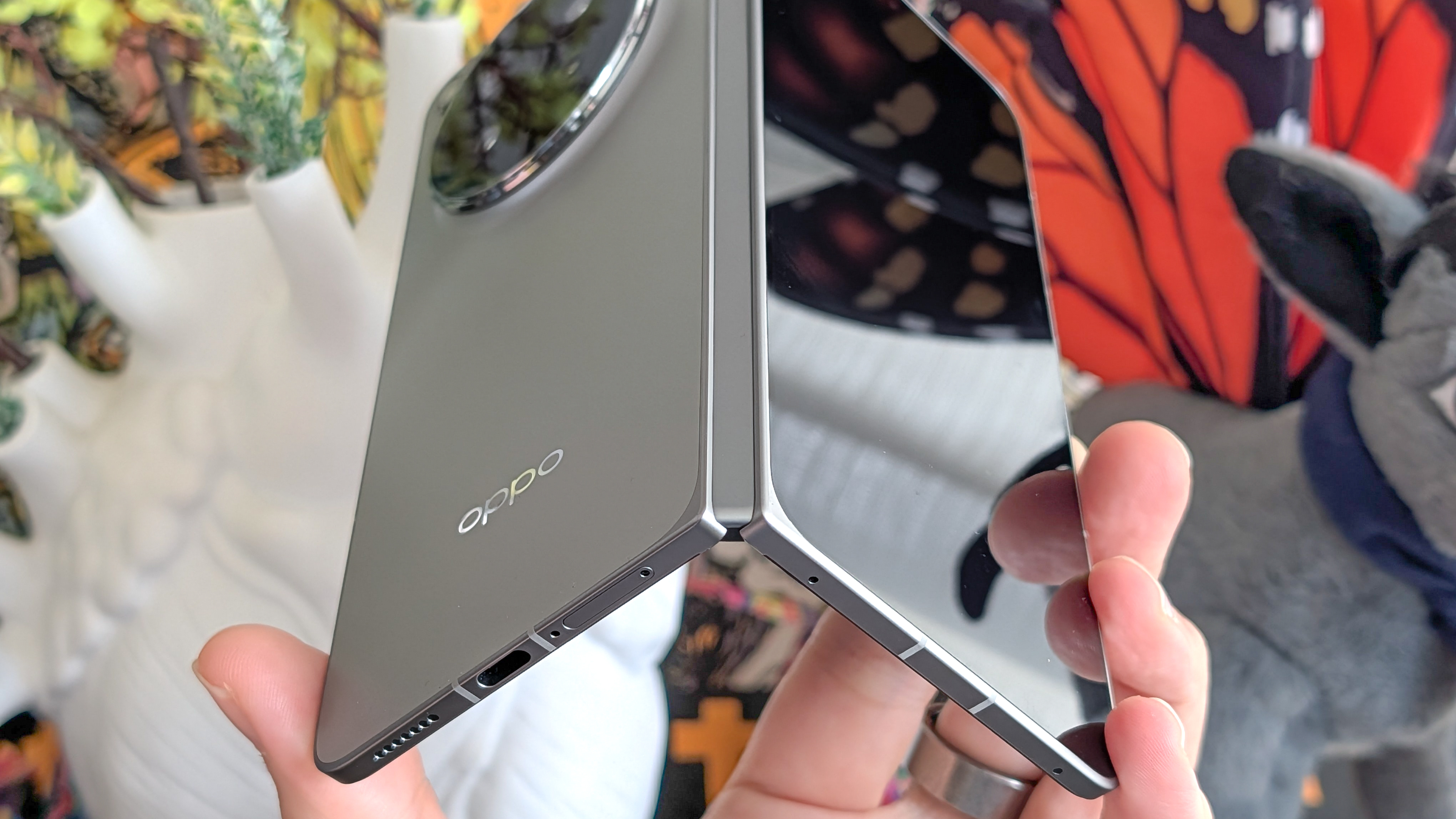 Oppo Find N6 held in the hand and folded halfway.