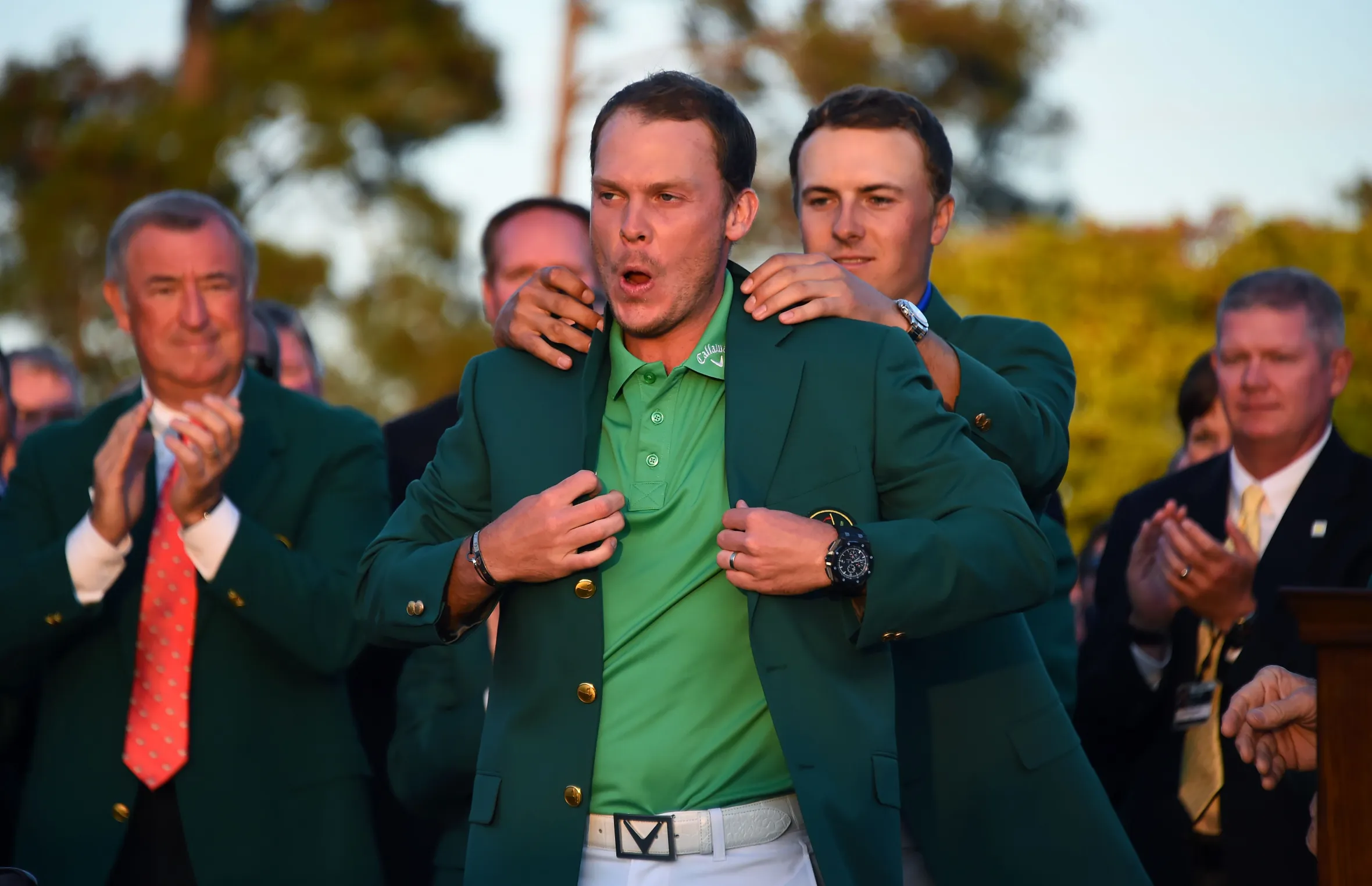 US golfer Jordan Spieth presents the Green Jacket to England's Danny Willett at the 80th Masters Golf Tournament.