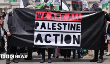A group of people holding a Palestine Action banner