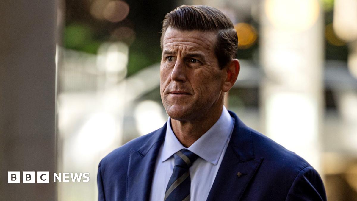 A front-on shot of Roberts-Smith looking pensively away from camera while wearing a suit and tie with strong background bokeh, as he walks along a street while arriving at the Federal Court in Sydney in May 2025.