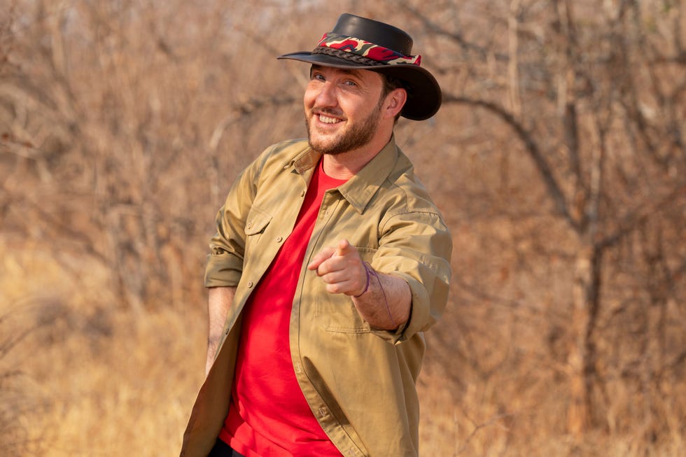 man pointing in a dry outdoor setting