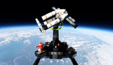 a triangular spacecraft made of white plastic blocks against the backdrop of Earth seen from space