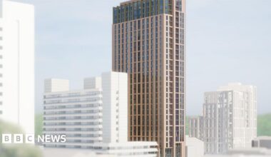 Artist's impression of the proposed building. A tall, slim brown building with many glass windows. The top three floors are slightly smaller with green framed windows. Existing buildings round the site are white so the new tower stands out in its surroundings