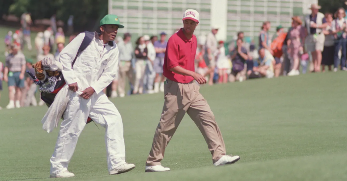 Tiger Woods and caddie Tommy Bennett walk a fairway during the 1995 Masters Tournament.