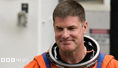 A digital illustration shows red clouds and water ice on the surface of Mars against the black abyss of space.