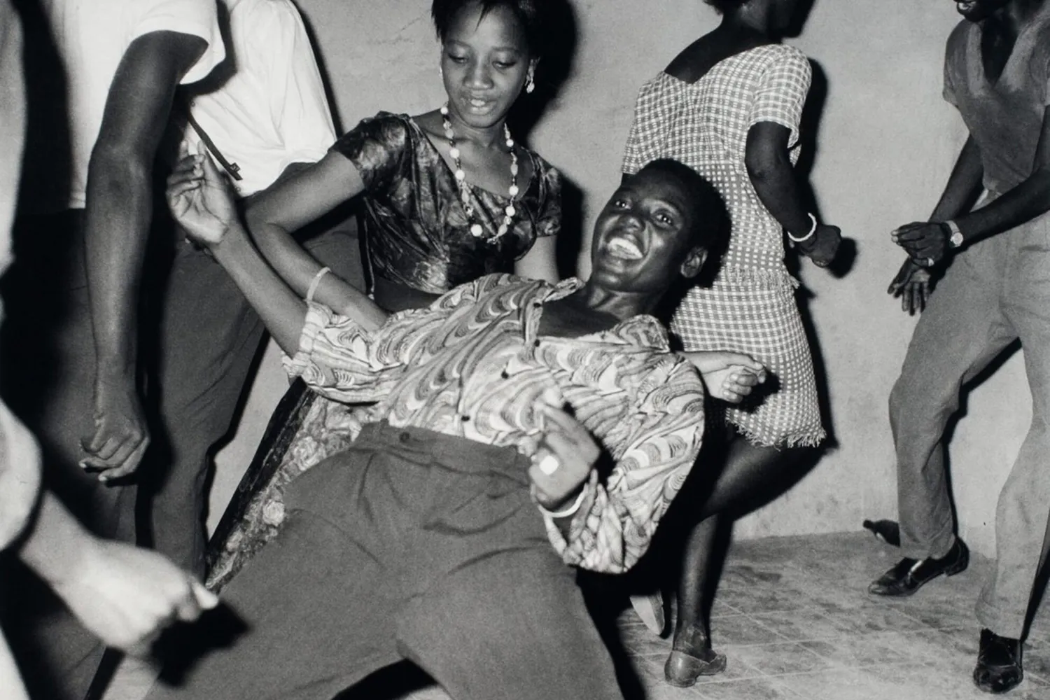 A person is shown dancing in a crowd, leaning back.