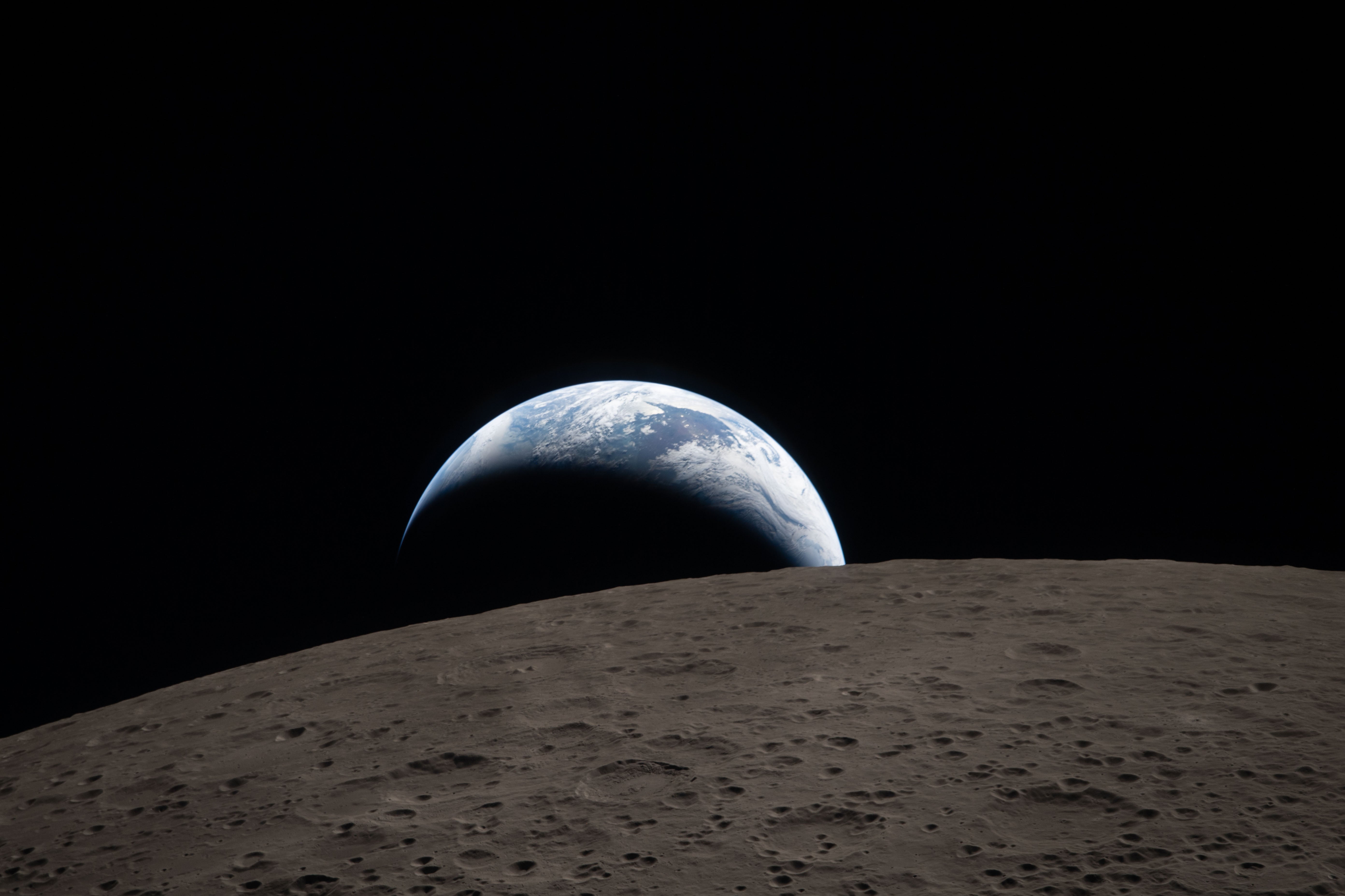 This image shows the Earth rising above the moon. It was taken by the Artemis II astronauts on April 6