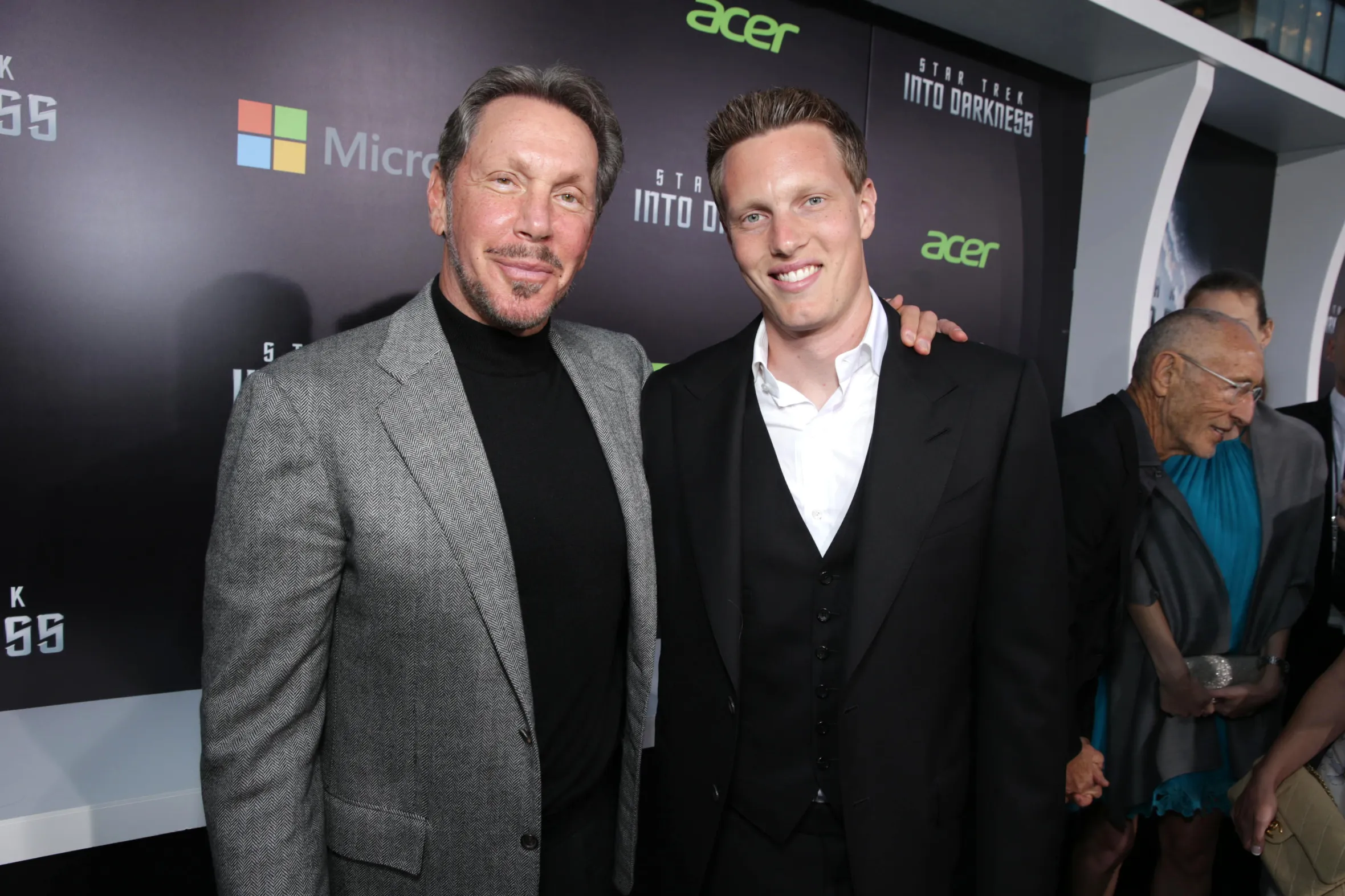 Larry Ellison and David Ellison standing on a red carpet at the premiere of "Star Trek Into Darkness".