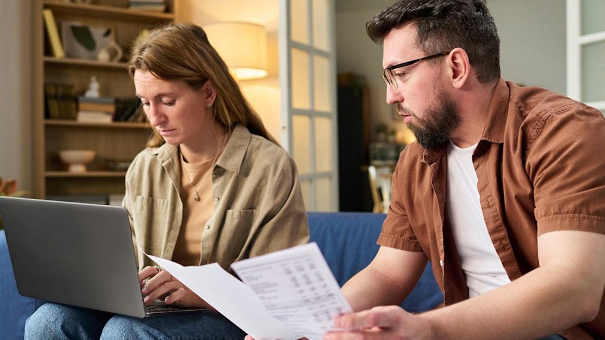 Couple at home organizing tax documents. - Pressmaster // Shutterstock