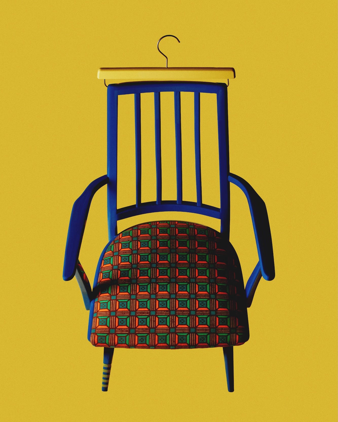 a colorful chair against a yellow background featuring a unique seating design and hanging element