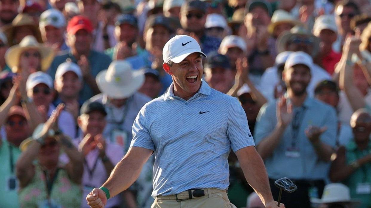 Rory McIlroy, a man with a blue polo shirt and white cap, celebrating a putt at The Masters in Augusta in April 2026.