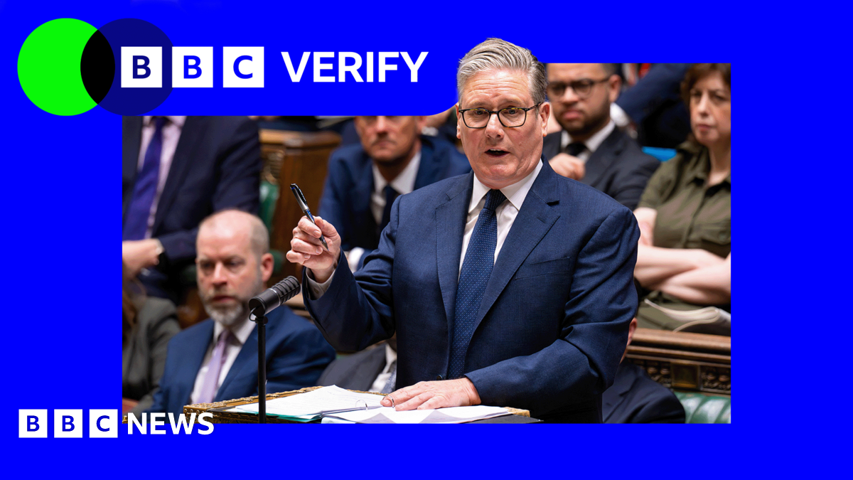 Prime Minister Sir Keir Starmer standing at the House of Commons dispatch box in a dark suit holding a pen in his right hand