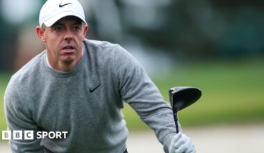 Rory McIlroy looks for his ball after hitting a tee shot