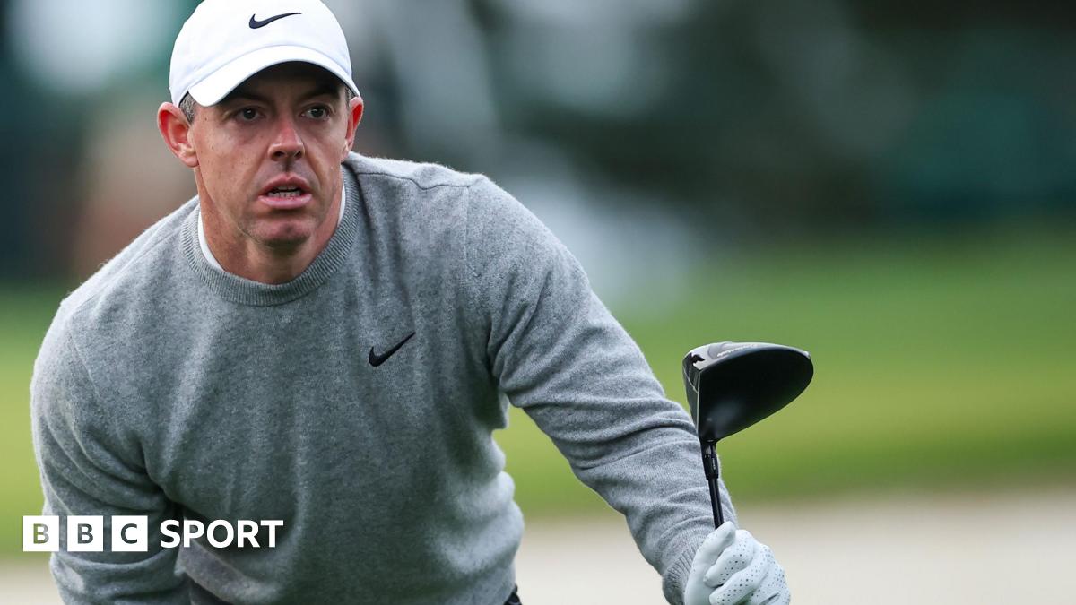 Rory McIlroy looks for his ball after hitting a tee shot