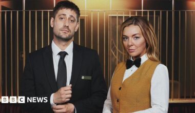 Left: Matty (played by actor Michael Socha) dressed as a croupier wearing a black suit in TV drama The Cage alongside his co-star Leanne (Sheridan Smith) wearing a mustard coloured waistcoat and white shirt. The scene is set in a casino.