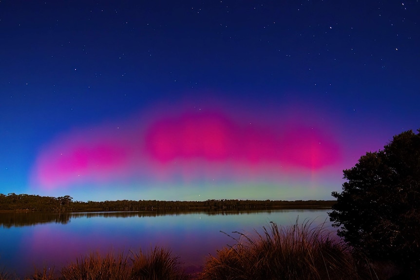 A red aurora shimmers above Molloy Island.