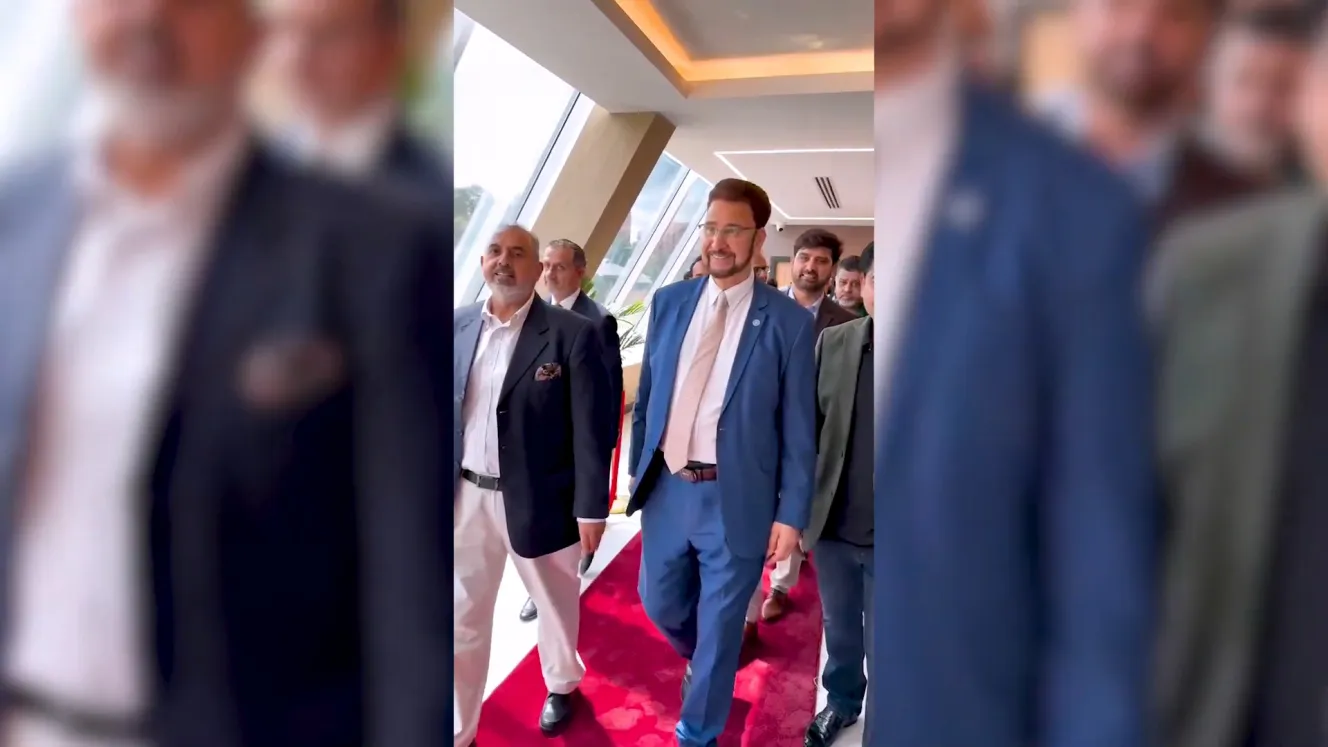 Afzal Khan MP and Baron Ahmed walking on a red carpet at a BT Properties event.