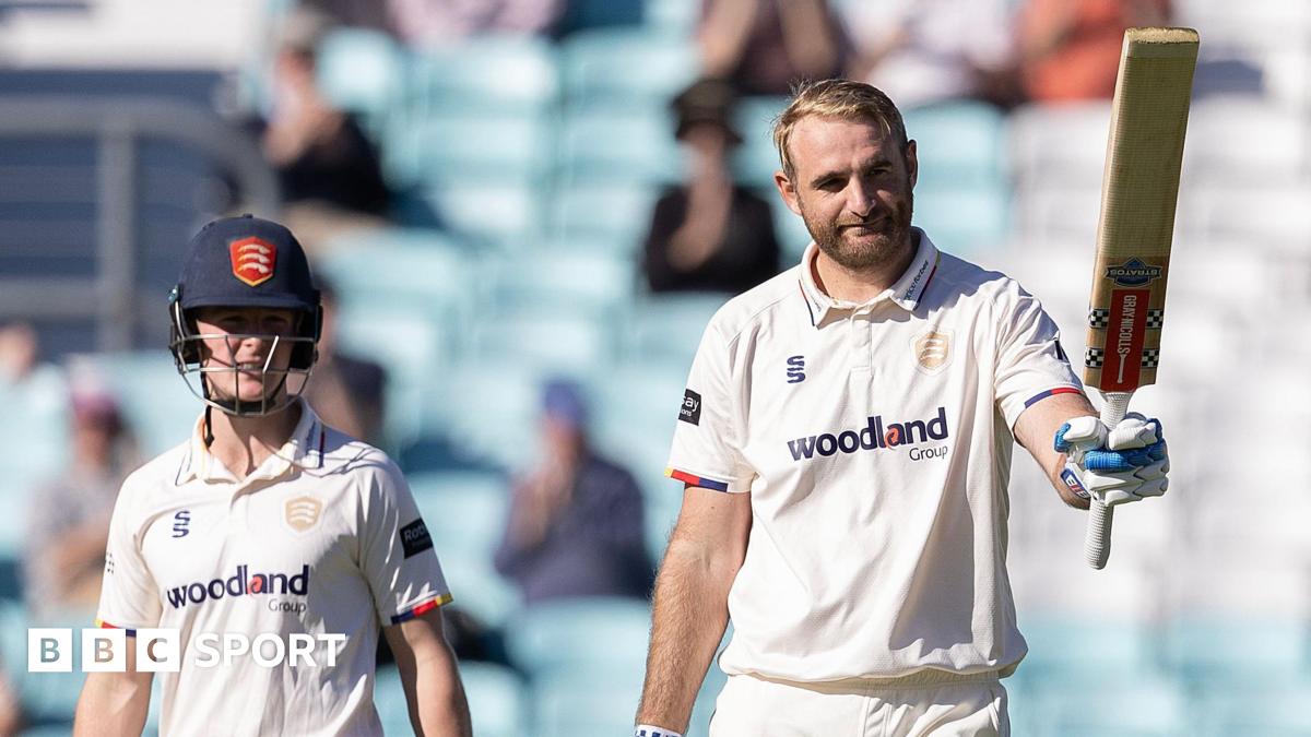Paul Walter raises his bat after reaching three figures for Essex