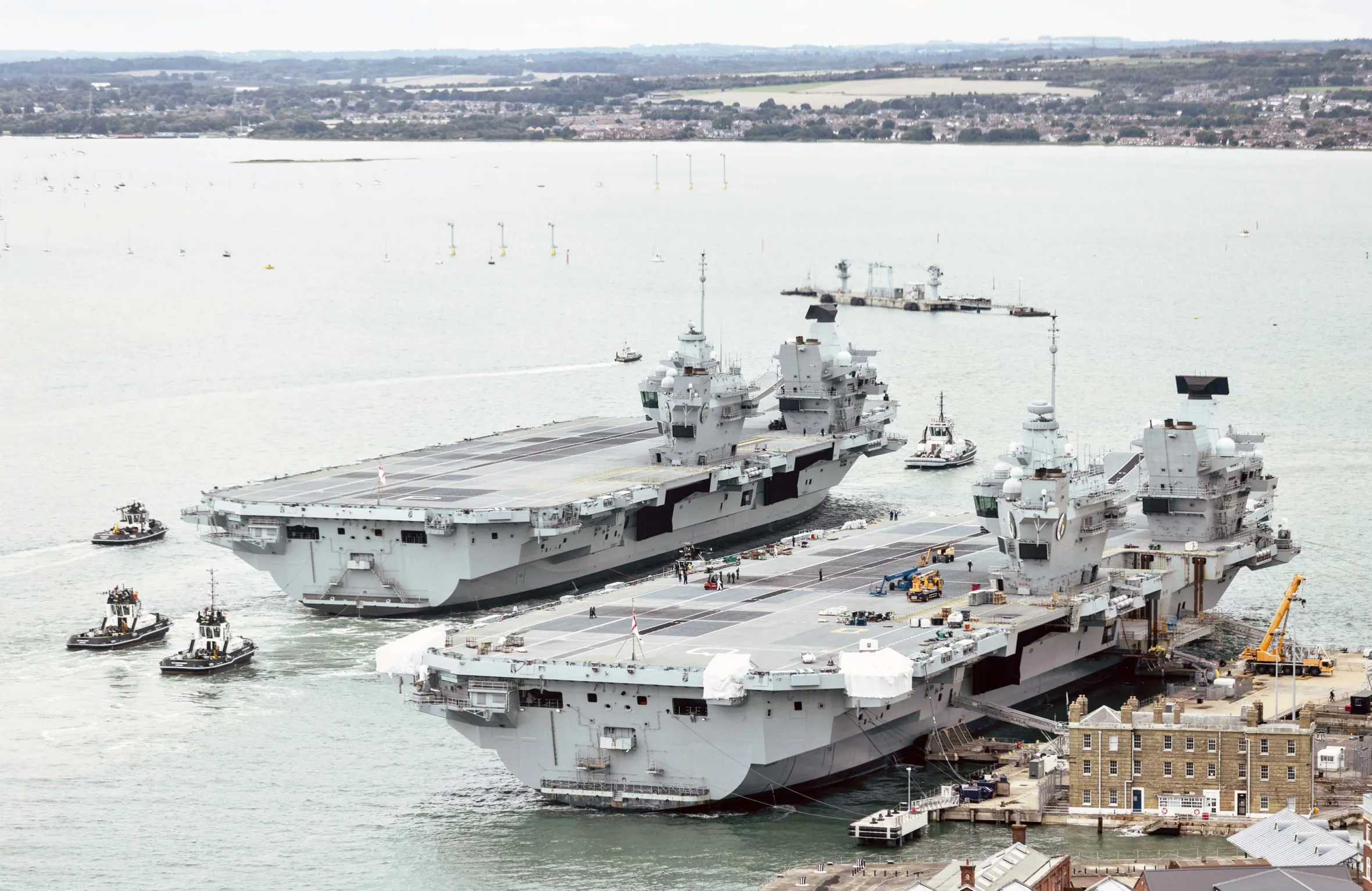 HMS Prince of Wales sails next to HMS Queen Elizabeth as the Royal Navy aircraft carrier returns to Portsmouth after repairs.